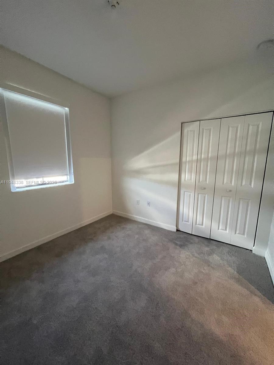 12908 Southwest 233rd Terrace Homestead, FL 33032 - Photo 12 of 23 a view of an empty room with a window