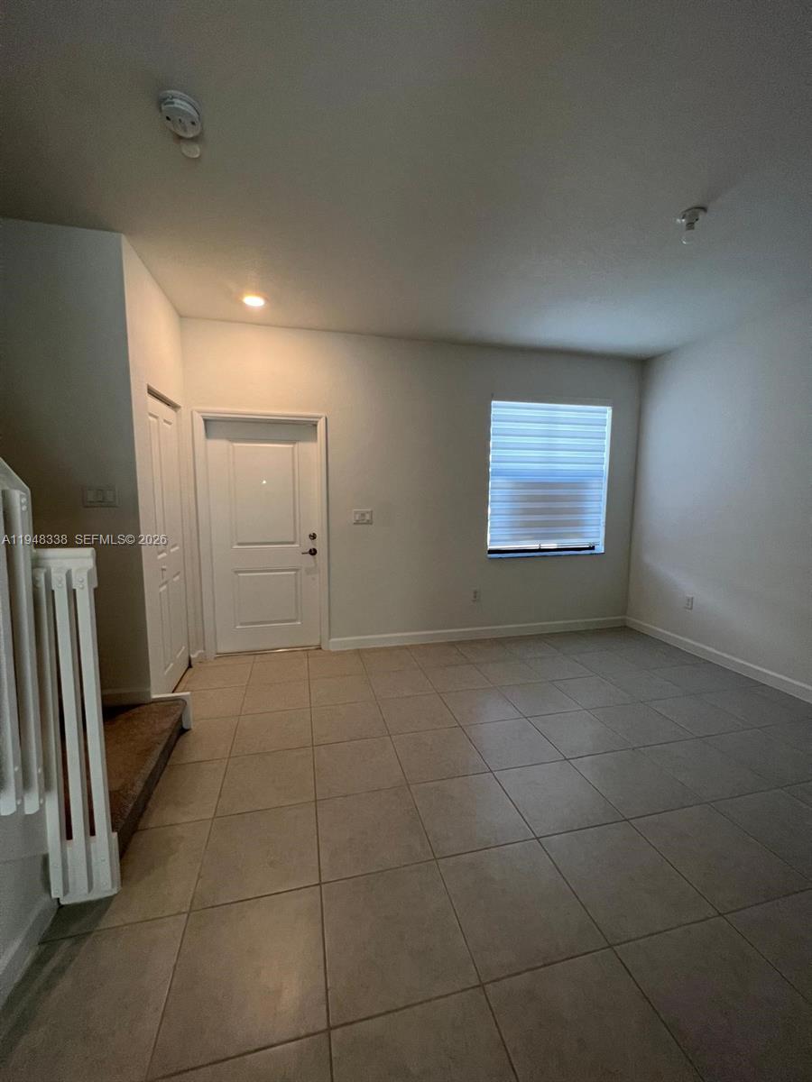 12908 Southwest 233rd Terrace Homestead, FL 33032 - Photo 9 of 23 a view of an empty room with a window