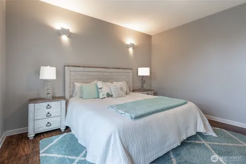 a bedroom with a bed and a night stand