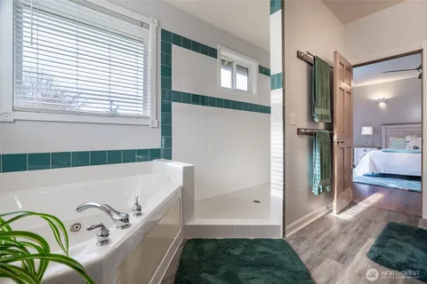 a bathroom with a bathtub and a shower