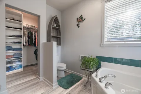a bathroom with a tub sink and toilet