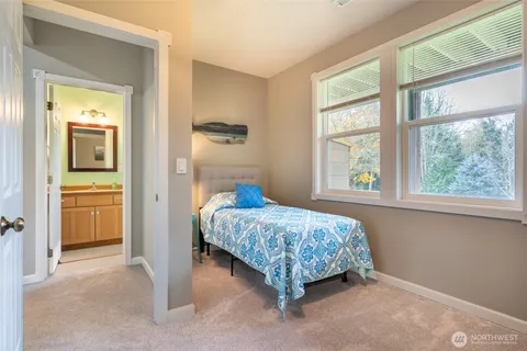 a bedroom with a bed and a view of bathroom