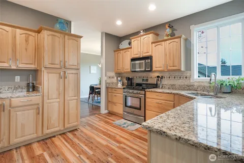 a kitchen with stainless steel appliances granite countertop a refrigerator sink and cabinets