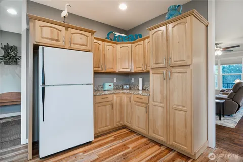 a kitchen with white cabinets and refrigerator