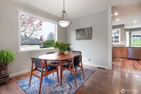 a view of a dining room with furniture window and wooden floor
