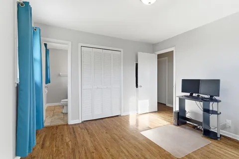 a bedroom with a bed and a chair in it