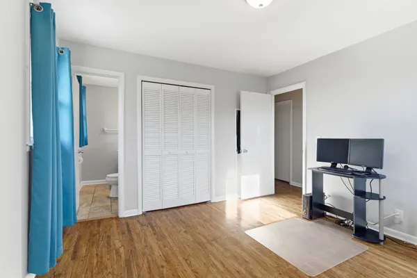 a bedroom with a bed and a chair in it