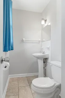 a bathroom with a sink toilet and mirror