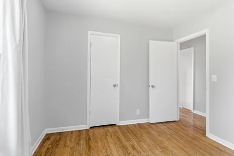 a view of room with wooden floor