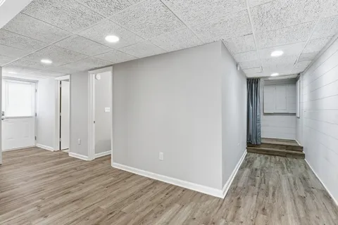 a view of a room with wooden floor