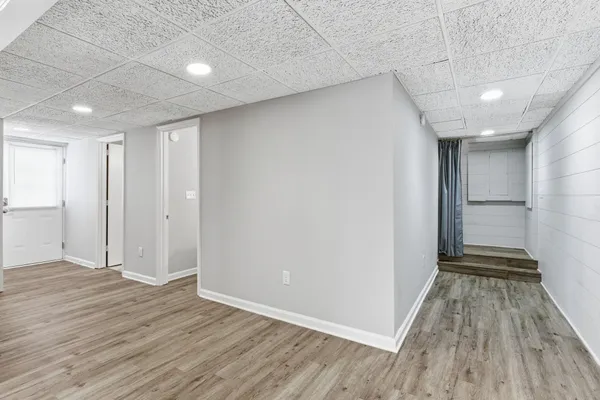a view of a room with wooden floor