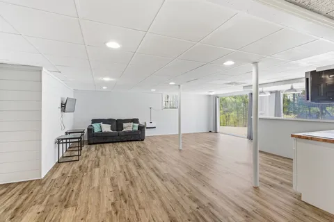 a view of a kitchen with a sink and wooden floor