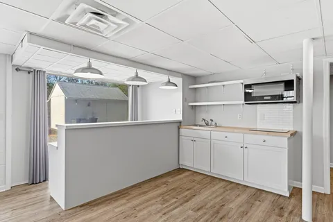 a kitchen with a refrigerator and a sink