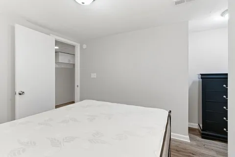 a bedroom with a bed and wooden floor