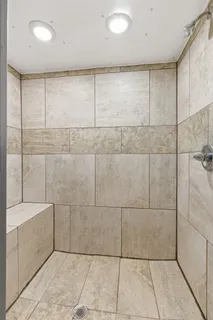 a bathroom with a bathtub and shower