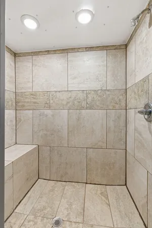 a bathroom with a bathtub and shower