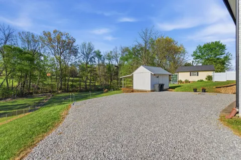 a view of a house with a yard and garage