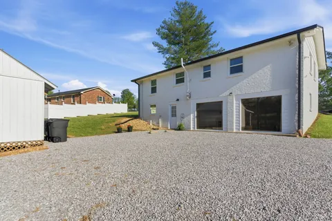 a view of a chairs and table in patio with a yard
