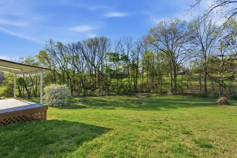 a kitchen with a refrigerator and a wooden floor