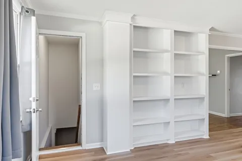 a view of walk in closet with empty racks