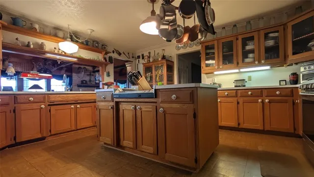 a kitchen with stainless steel appliances granite countertop a sink a stove and a microwave