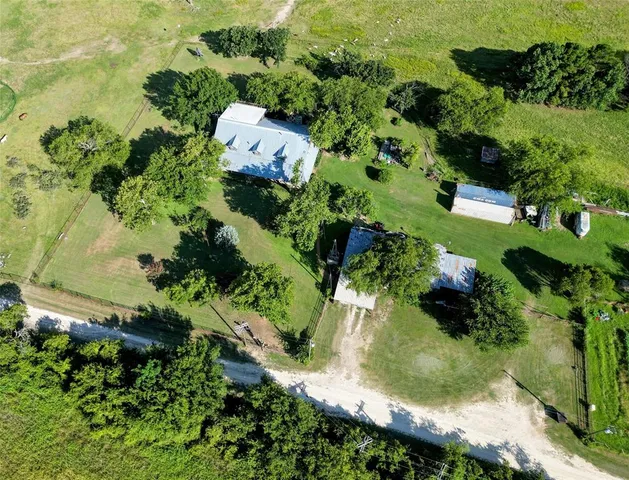 an aerial view of a house with a yard