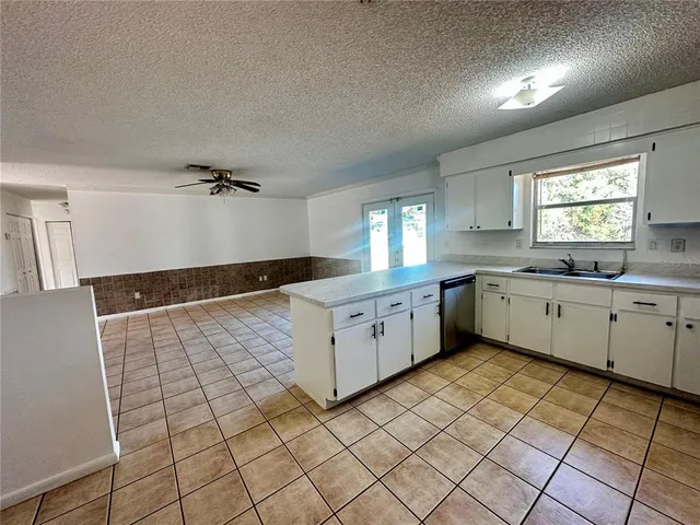 a view of a utility room with cabinets