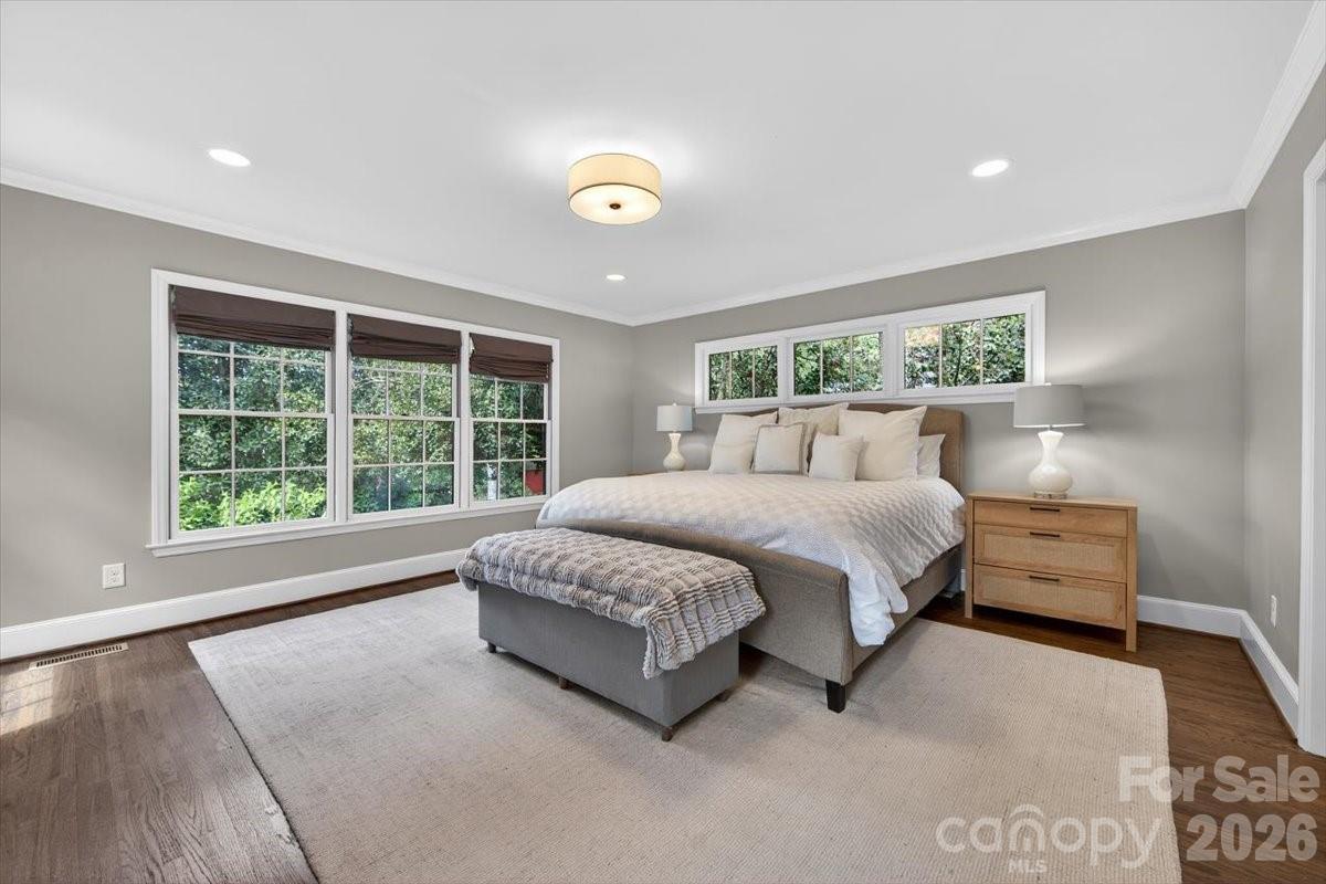 308 Robmont Road Charlotte, NC 28270 - Photo 19 of 43 a spacious bedroom with a bed lamp and a large window