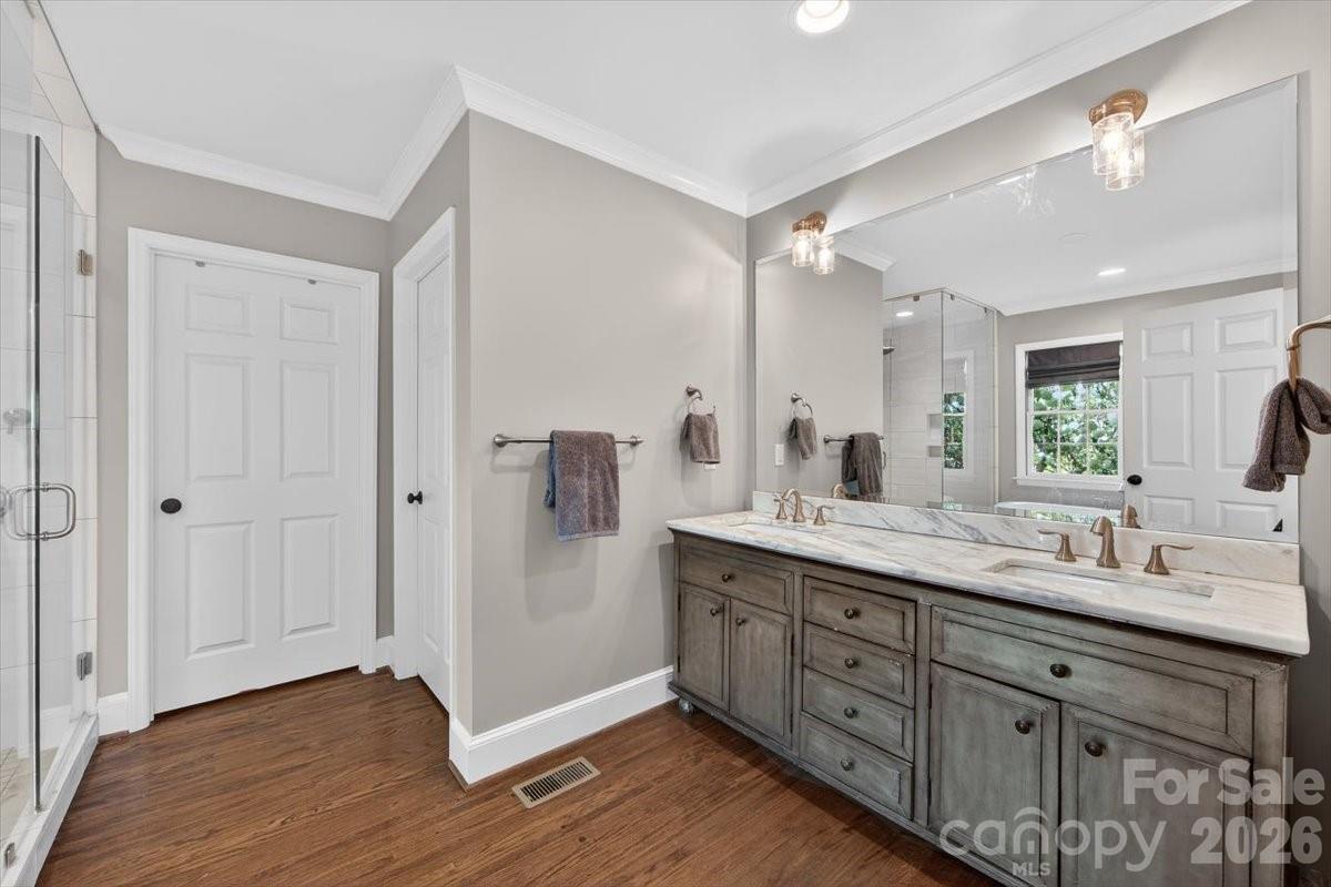 308 Robmont Road Charlotte, NC 28270 - Photo 22 of 43 a bathroom with a double vanity sink and mirror with shower