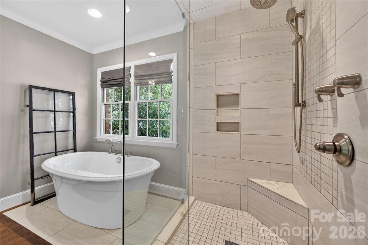 308 Robmont Road Charlotte, NC 28270 - Photo 23 of 43 a white bath tub sitting in a bathroom next to a window