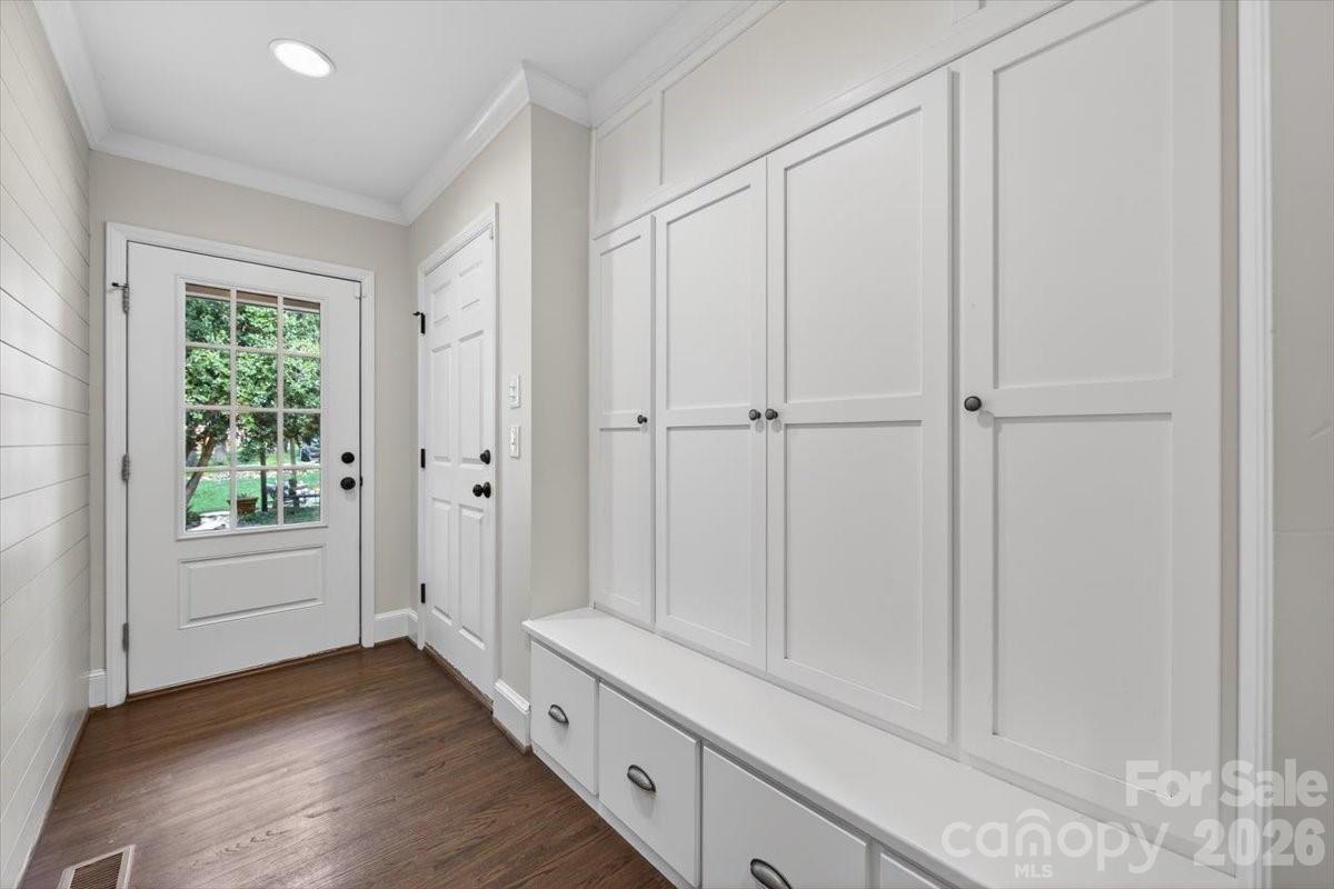 308 Robmont Road Charlotte, NC 28270 - Photo 25 of 43 a hallway with white cabinets and wooden floor