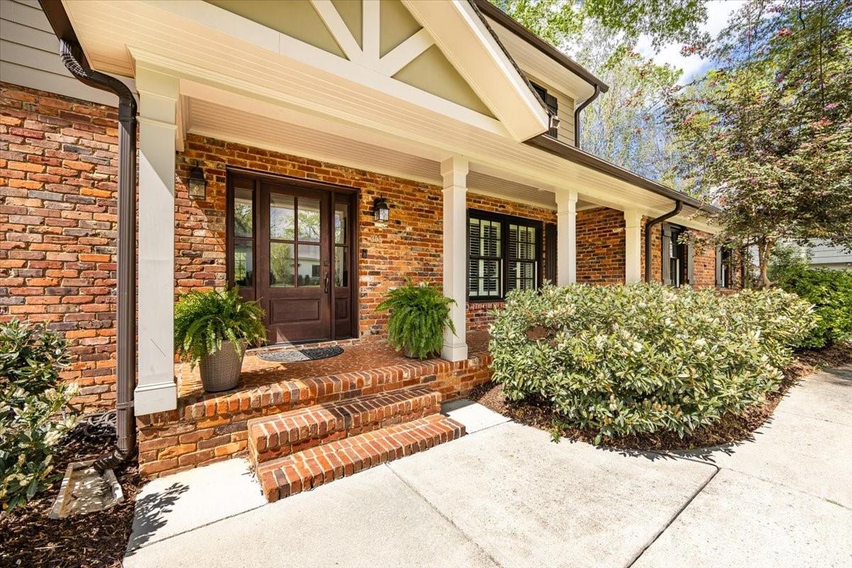 308 Robmont Road Charlotte, NC 28270 - Photo 3 of 43 a view of a house with potted plants and a table and chairs