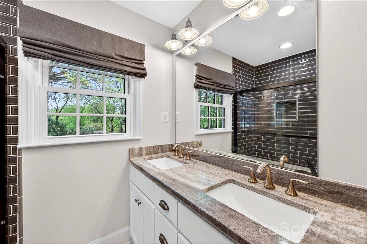 308 Robmont Road Charlotte, NC 28270 - Photo 31 of 43 a bathroom with a granite countertop sink and large mirror