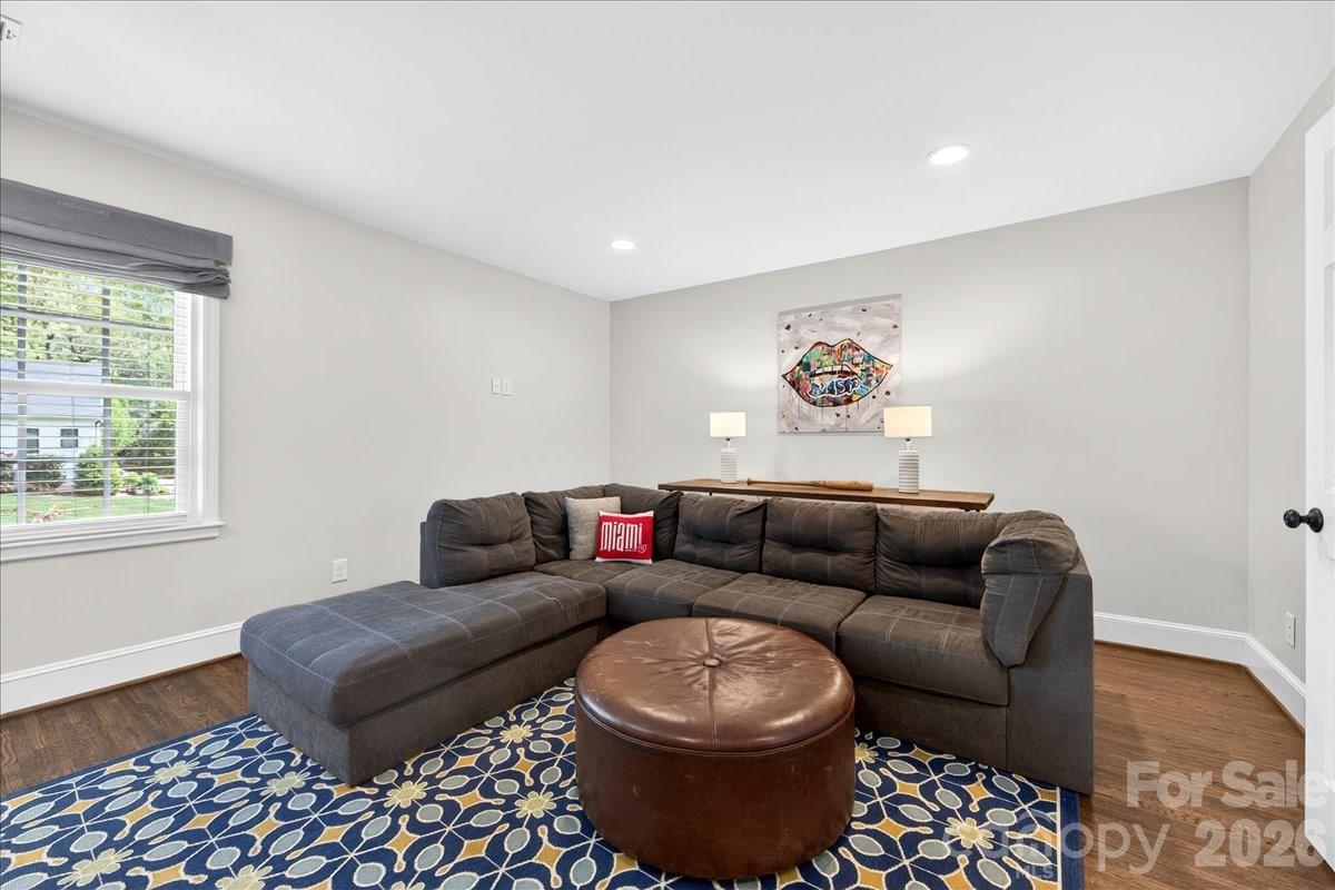 308 Robmont Road Charlotte, NC 28270 - Photo 33 of 43 a living room with a couch and a table with wooden floor