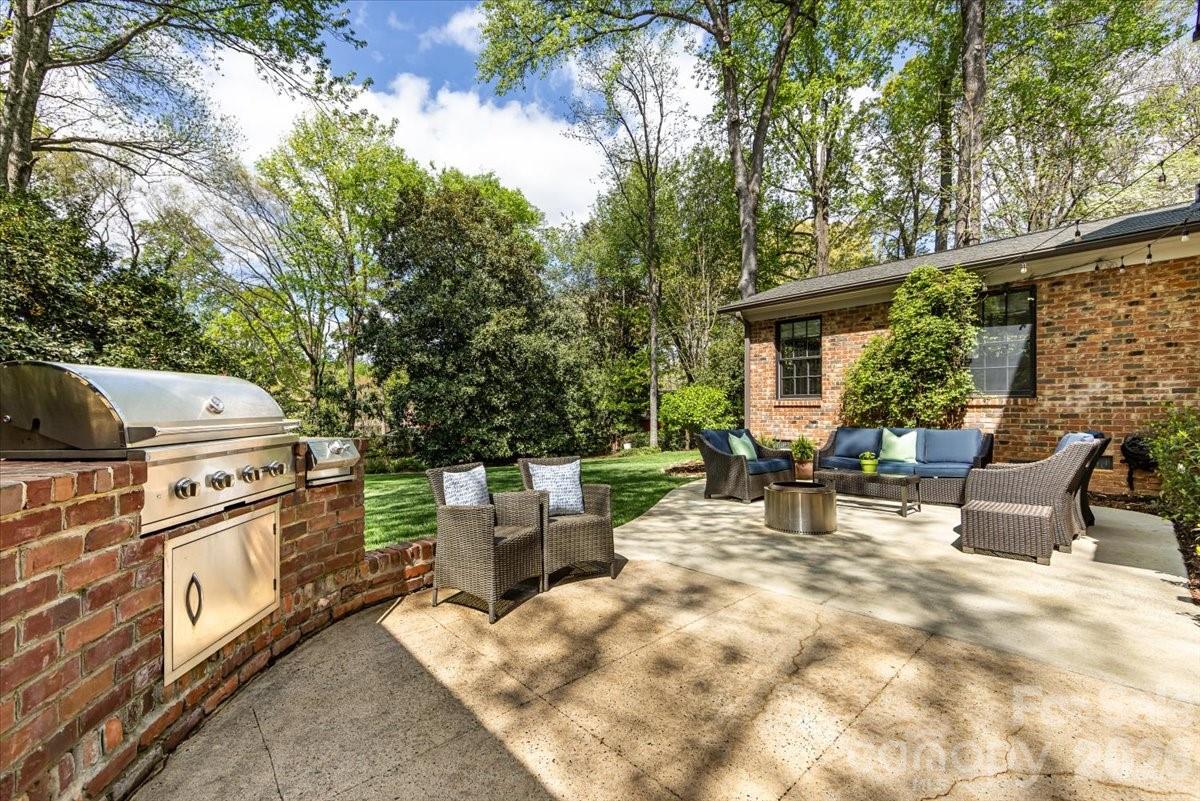 308 Robmont Road Charlotte, NC 28270 - Photo 38 of 43 a view of a patio with couches and chairs under an umbrella