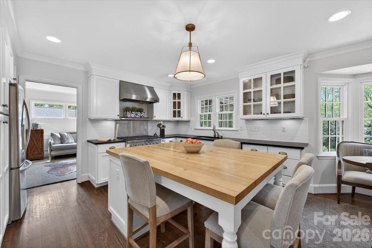 308 Robmont Road Charlotte, NC 28270 - Photo 9 of 43 a living room with stainless steel appliances granite countertop a kitchen island a stove a table and chairs