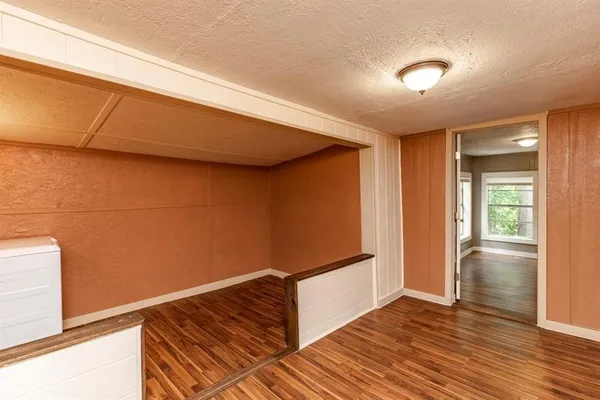 a view of wooden floor and windows in a room