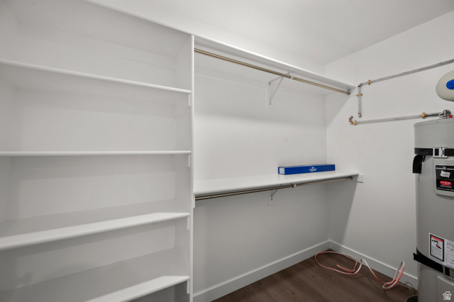 1554 Pheasant Road Eagle Mountain, UT 84005 - Photo 14 of 29 Walk in closet with dark wood-style flooring and water heater