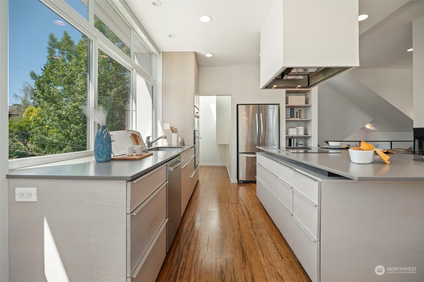 4322 Eastern Avenue North Seattle, WA 98103 - Photo 11 of 39 a kitchen with granite countertop a sink a counter top space stainless steel appliances and a large window