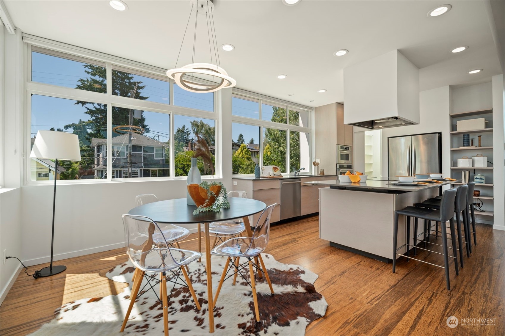 4322 Eastern Avenue North Seattle, WA 98103 - Photo 17 of 39 a kitchen with stainless steel appliances granite countertop a stove and a dining table with chairs