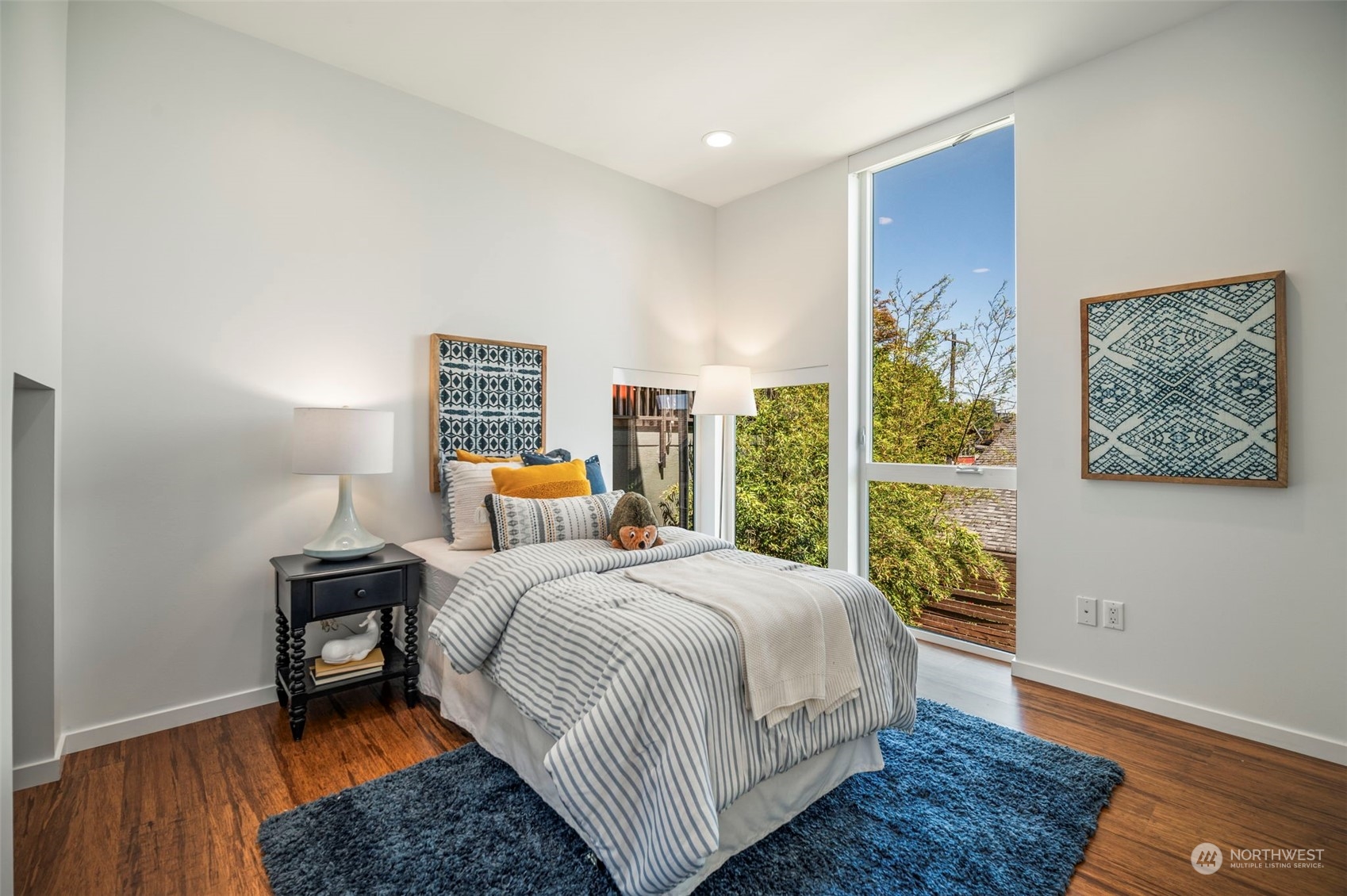 4322 Eastern Avenue North Seattle, WA 98103 - Photo 25 of 39 a bedroom with a bed and wooden floor