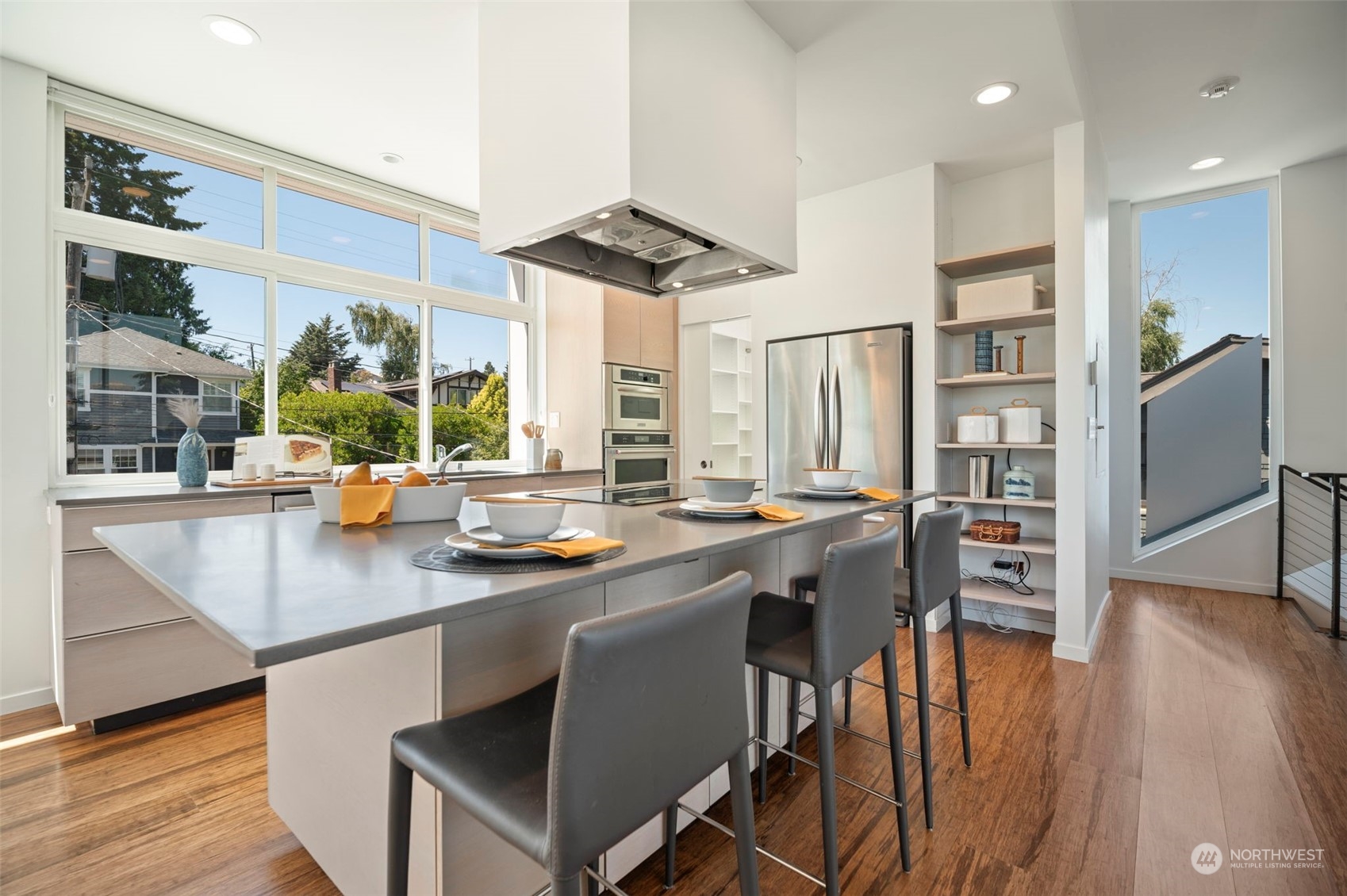 4322 Eastern Avenue North Seattle, WA 98103 - Photo 9 of 39 a kitchen with stainless steel appliances granite countertop a stove a refrigerator a sink and a dining table with wooden floor
