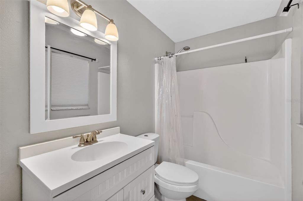 36 Bay Ridge Loop Mascotte, FL 34753 - Photo 20 of 32 a bathroom with a sink toilet vanity and shower