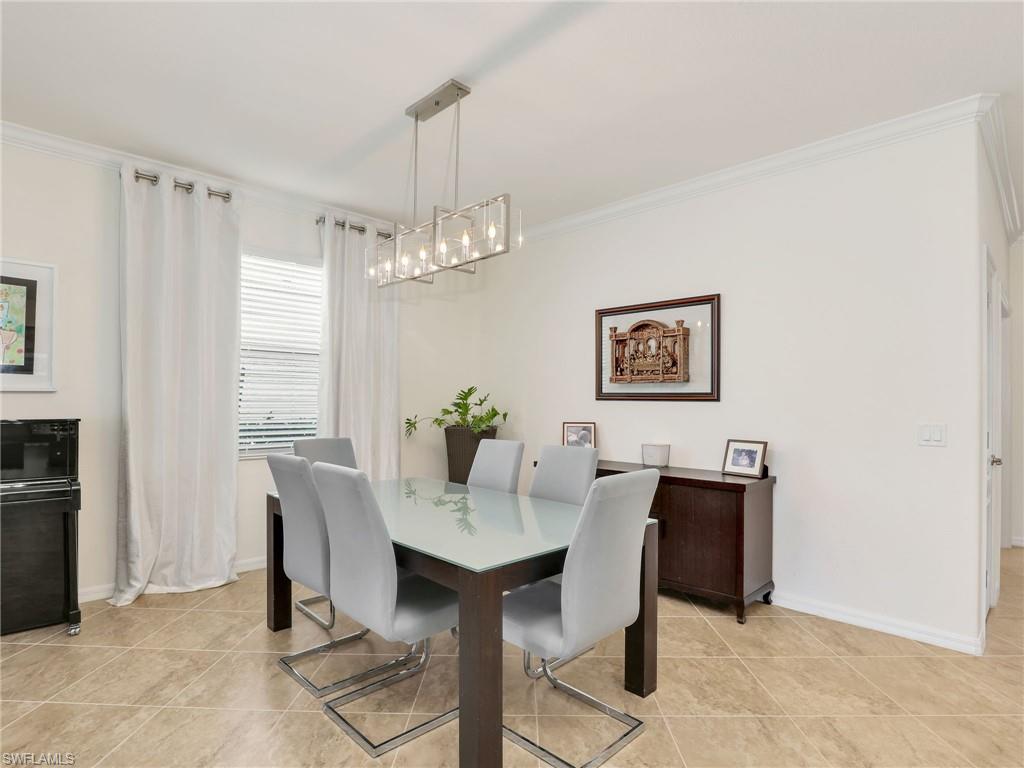 4212 Raffia Palm Circle Naples, FL 34119 - Photo 13 of 49 a view of a dining room with furniture