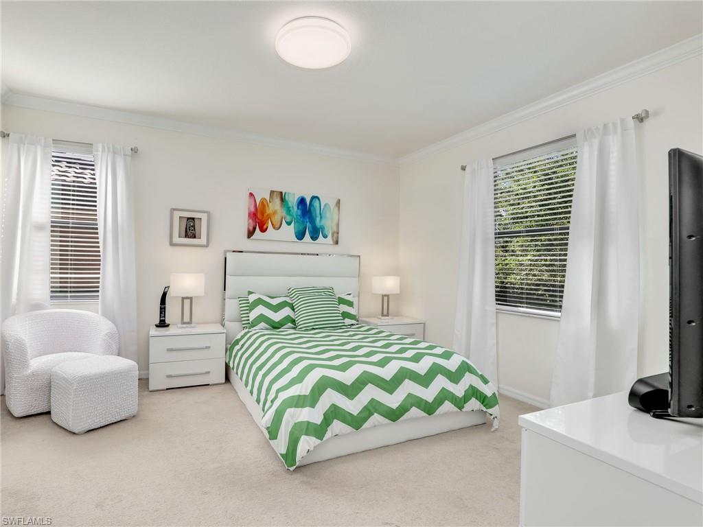 4212 Raffia Palm Circle Naples, FL 34119 - Photo 19 of 49 a bedroom with a bed and a couch