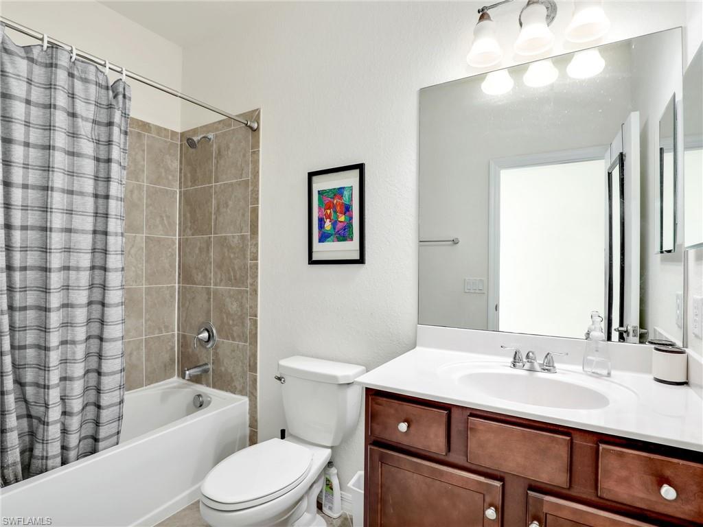 4212 Raffia Palm Circle Naples, FL 34119 - Photo 25 of 49 a bathroom with a sink a toilet and shower