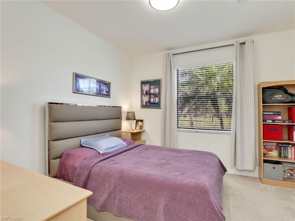 4212 Raffia Palm Circle Naples, FL 34119 - Photo 26 of 49 a bedroom with a bed and a dresser next to a window