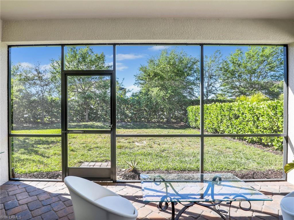 4212 Raffia Palm Circle Naples, FL 34119 - Photo 31 of 49 a view of a city from a dining room with large windows
