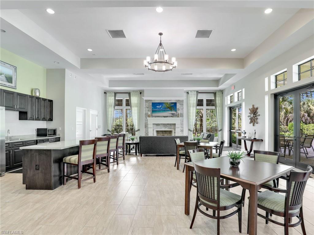 4212 Raffia Palm Circle Naples, FL 34119 - Photo 42 of 49 a view of a dining room with furniture window and outside view