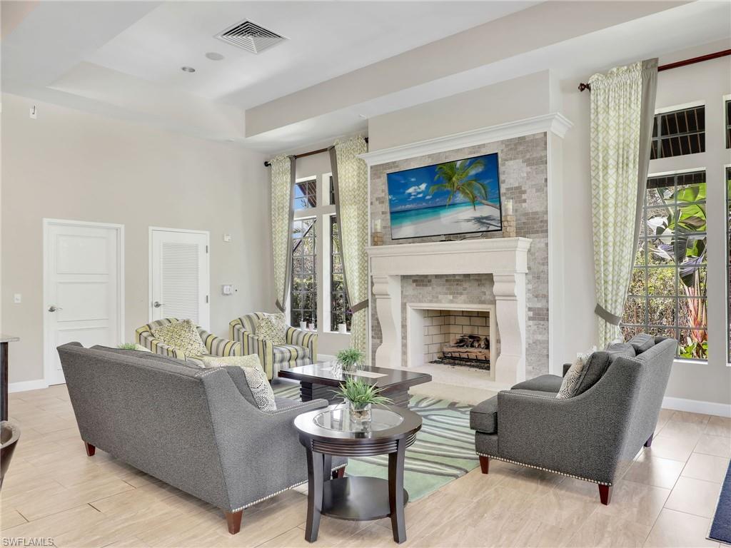 4212 Raffia Palm Circle Naples, FL 34119 - Photo 44 of 49 a living room with furniture and a fireplace